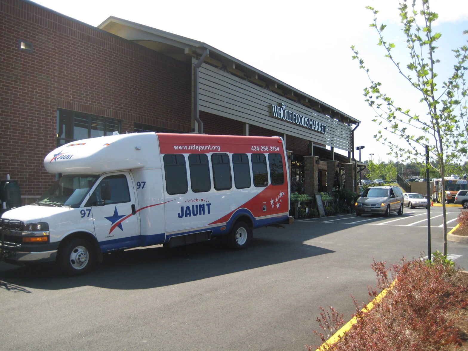 A JAUNT bus in front of a grocery store, a church with handicap parking, and a ramp leading to the Pavilion