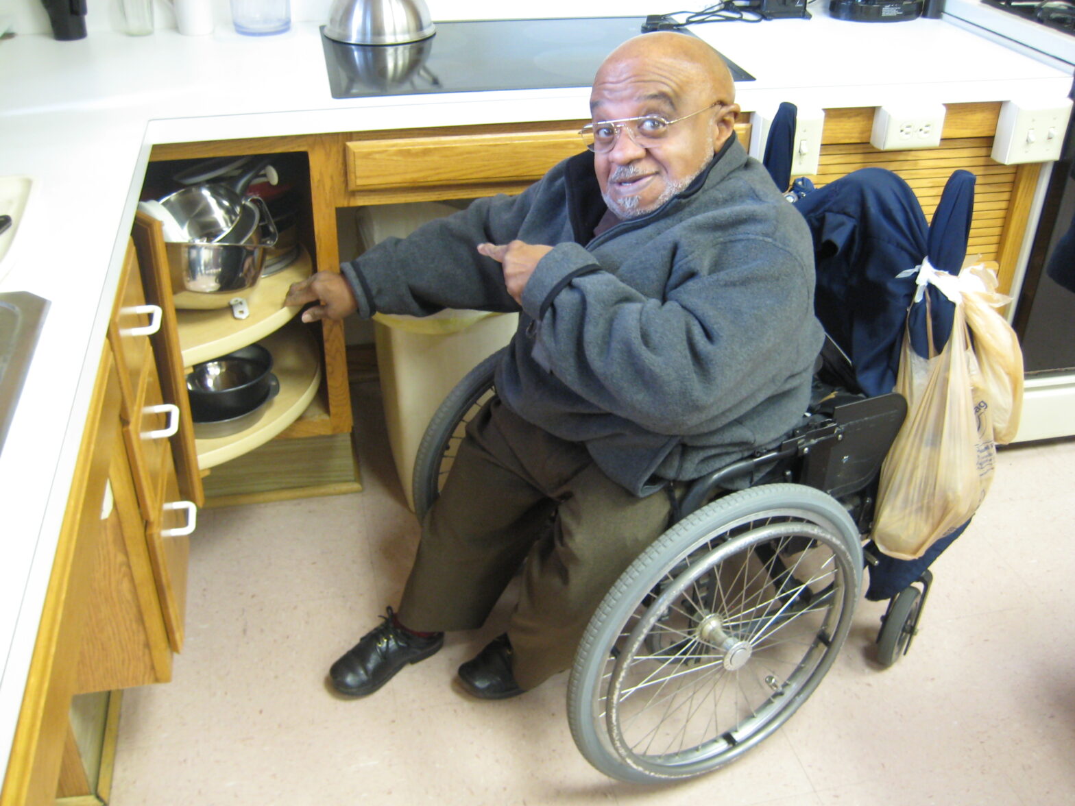 An IRC employee shows off accessible kitchen design